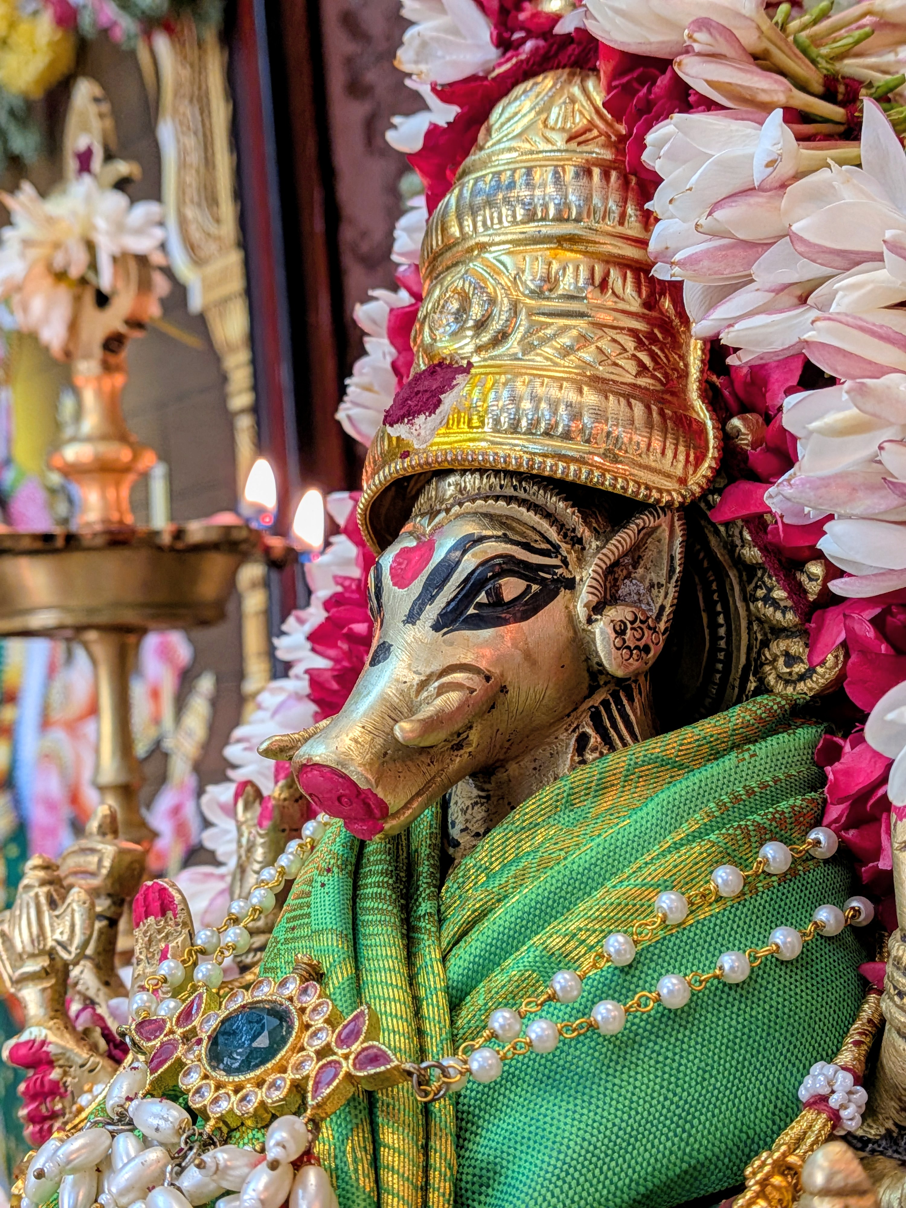 Close-up of Goddess Varahi murti in a green saree with a golden crown for Panchami pooja